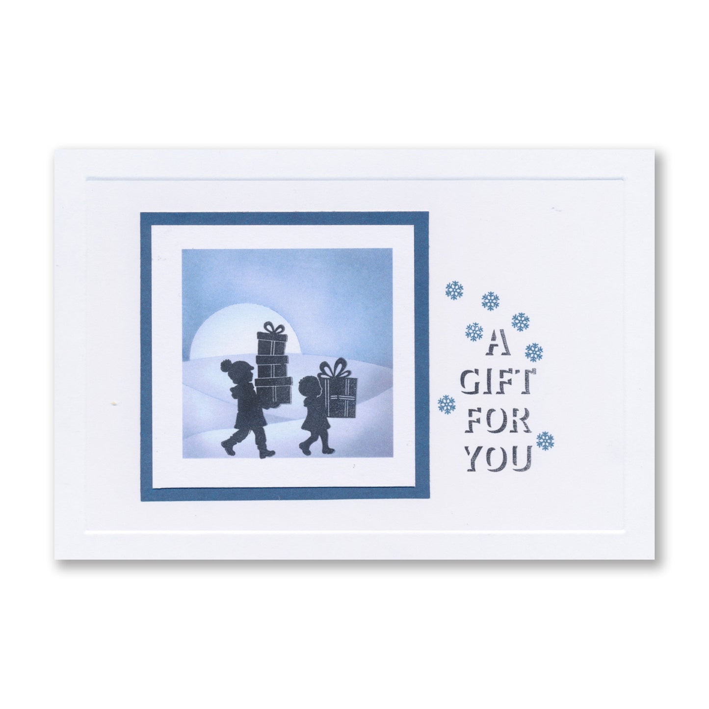 Handmade Christmas card featuring two figures carrying presents with the "A Gift for You" sentiment created with the Wee Christmas Friends & Family Silhouettes A5 & A7 Stamp Collection